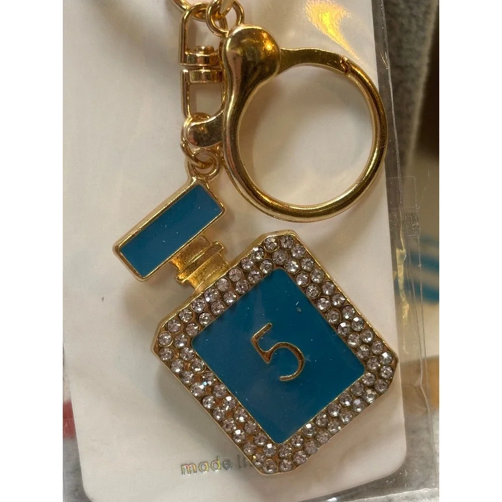 #5. Turquoise bag charm keychain perfume bottle-inspired.